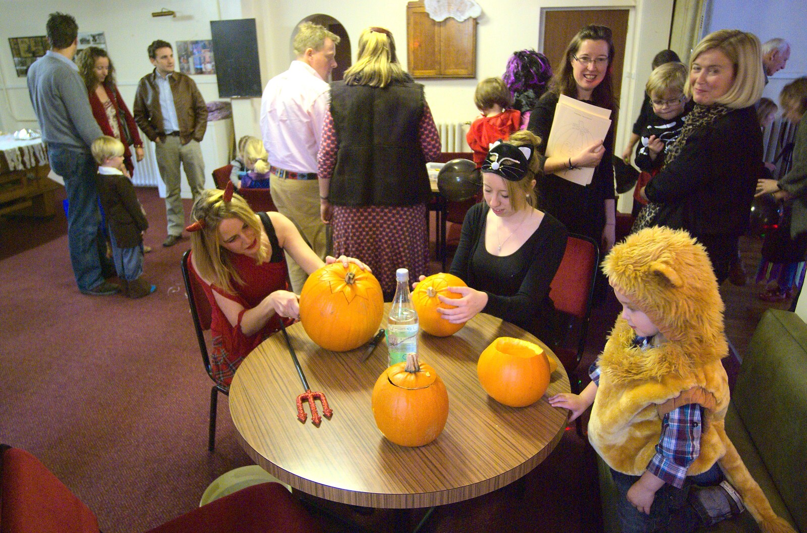 Allyson and Ellie carve pumpkins as Fred watches from Amelia's Birthday, Brome Village Hall, Suffolk - 29th October 2011