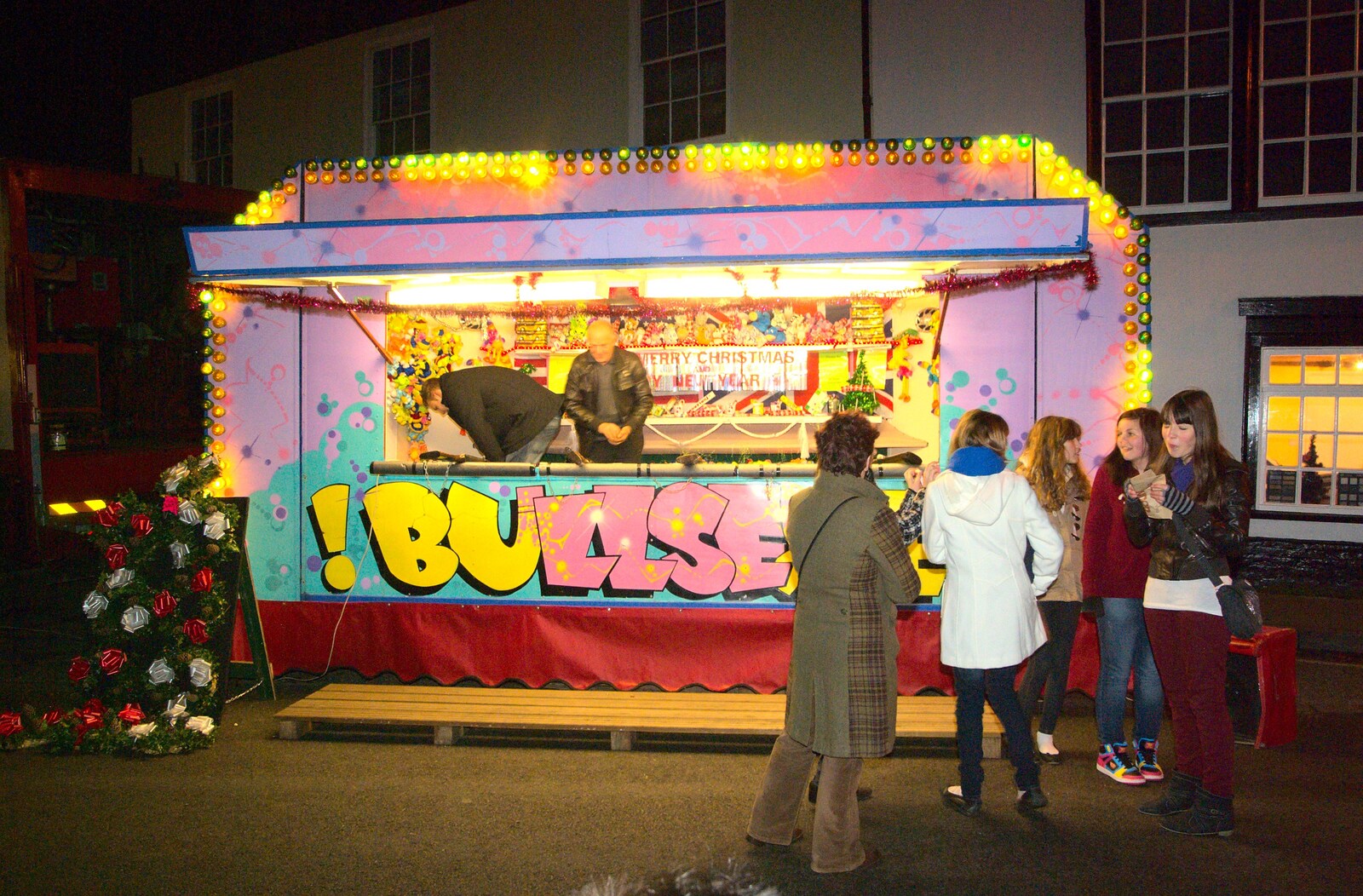 Girls hang around by a fairground stall from The Christmas Lights Switch-On, Eye, Suffolk - 2nd December 2011
