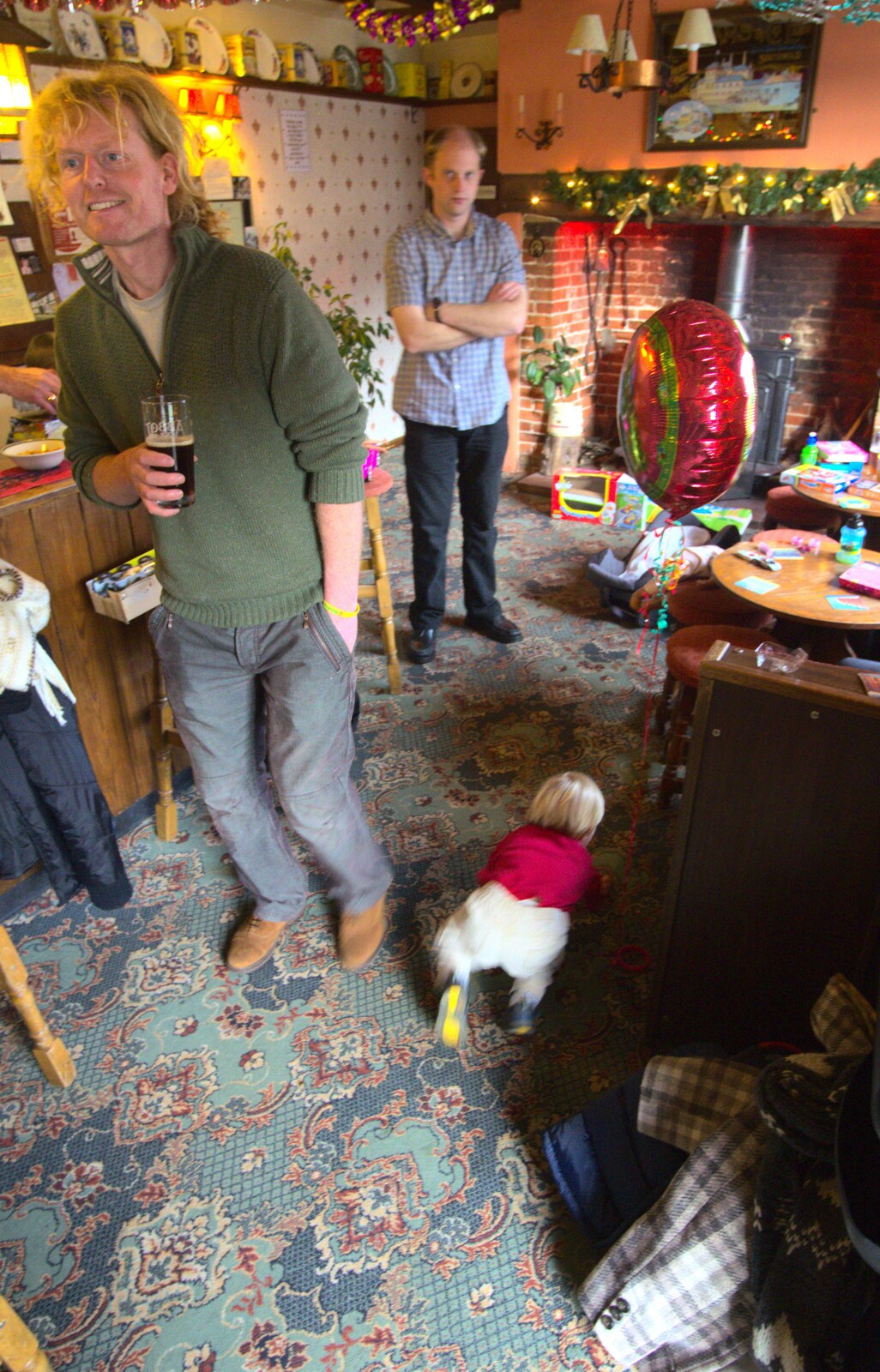Oak scoots around on the floor of the pub from Christmas Day in the Swan Inn, Brome, Suffolk - 25th December 2011