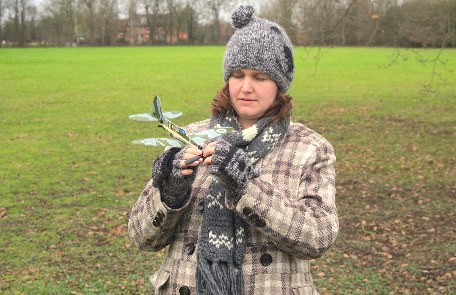 Isobel winds up the toy Spitfire from The BBs do New Year's Eve at the George and Dragon, East Harling, Norfolk - 31st December 2011