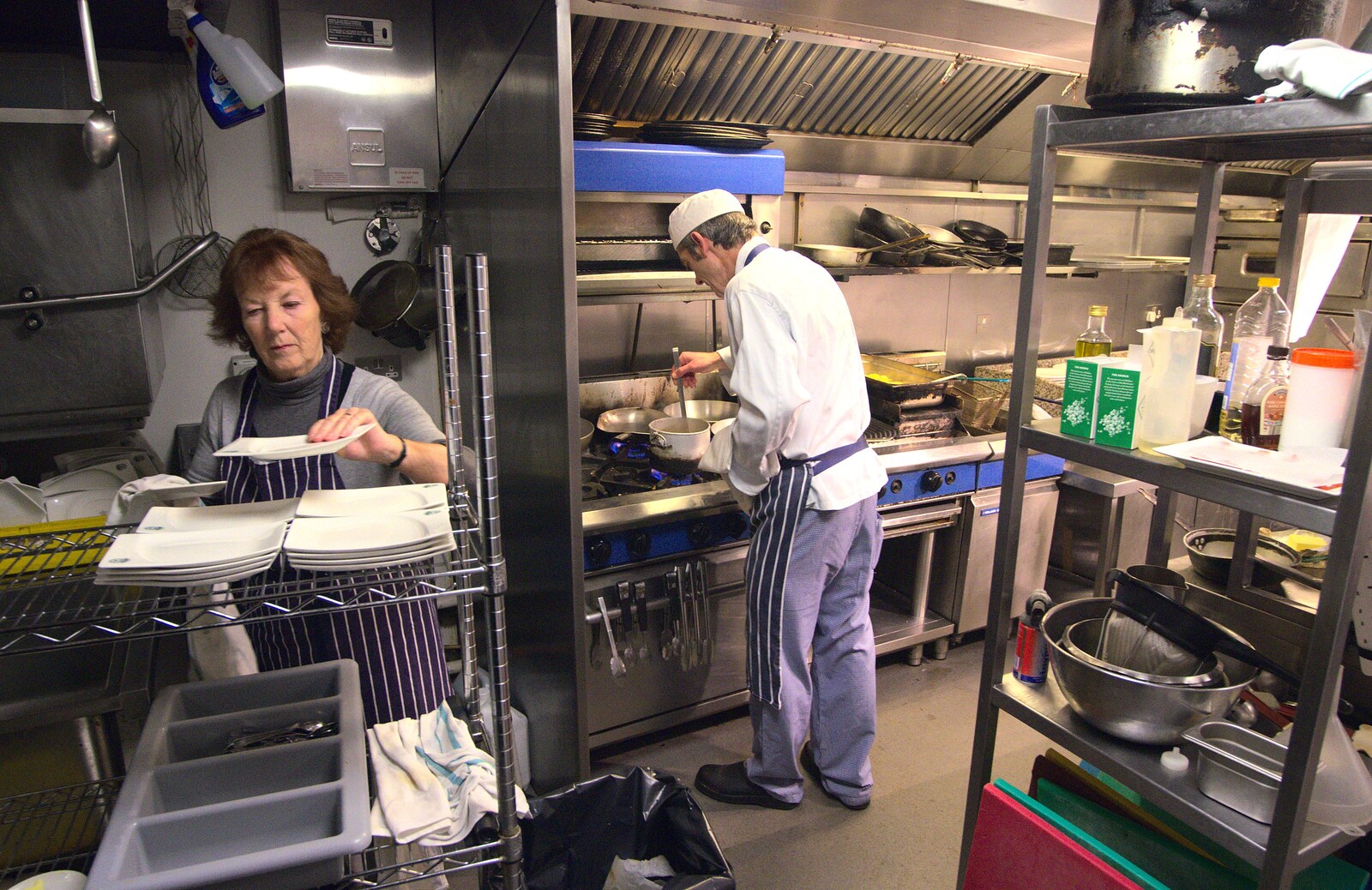 Wayne stirs whilst Caro's mum prepares crockery from Nom Nom's Popup Restaurant, Dublin, Ireland - 7th January 2012