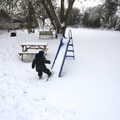 Fred kicks snow up a slide, A Snowy February Miscellany, Suffolk - 7th February 2012