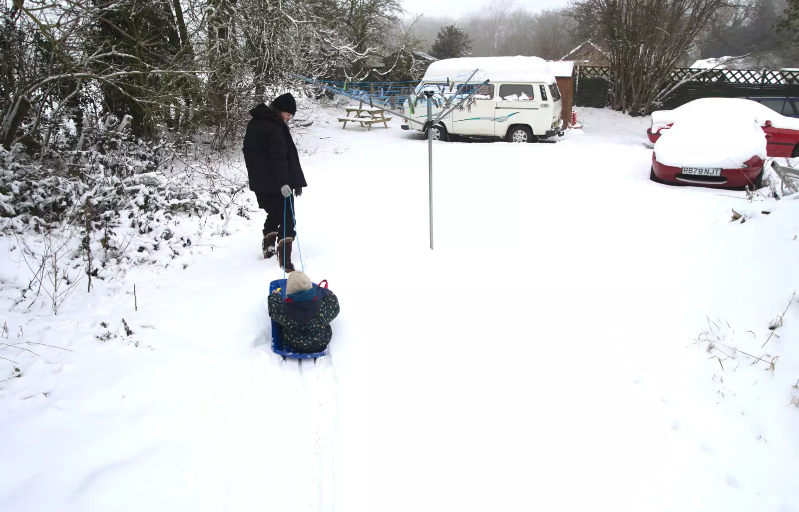 Isobel hauls Fred off, from A Snowy February Miscellany, Suffolk - 7th February 2012