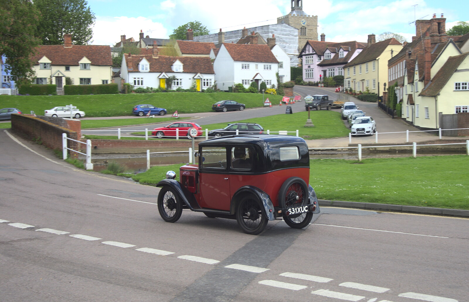 A cute Austin 7 trundles past from The BSCC Cycling Weekend, The Swan Inn, Thaxted, Essex - 12th May 2012