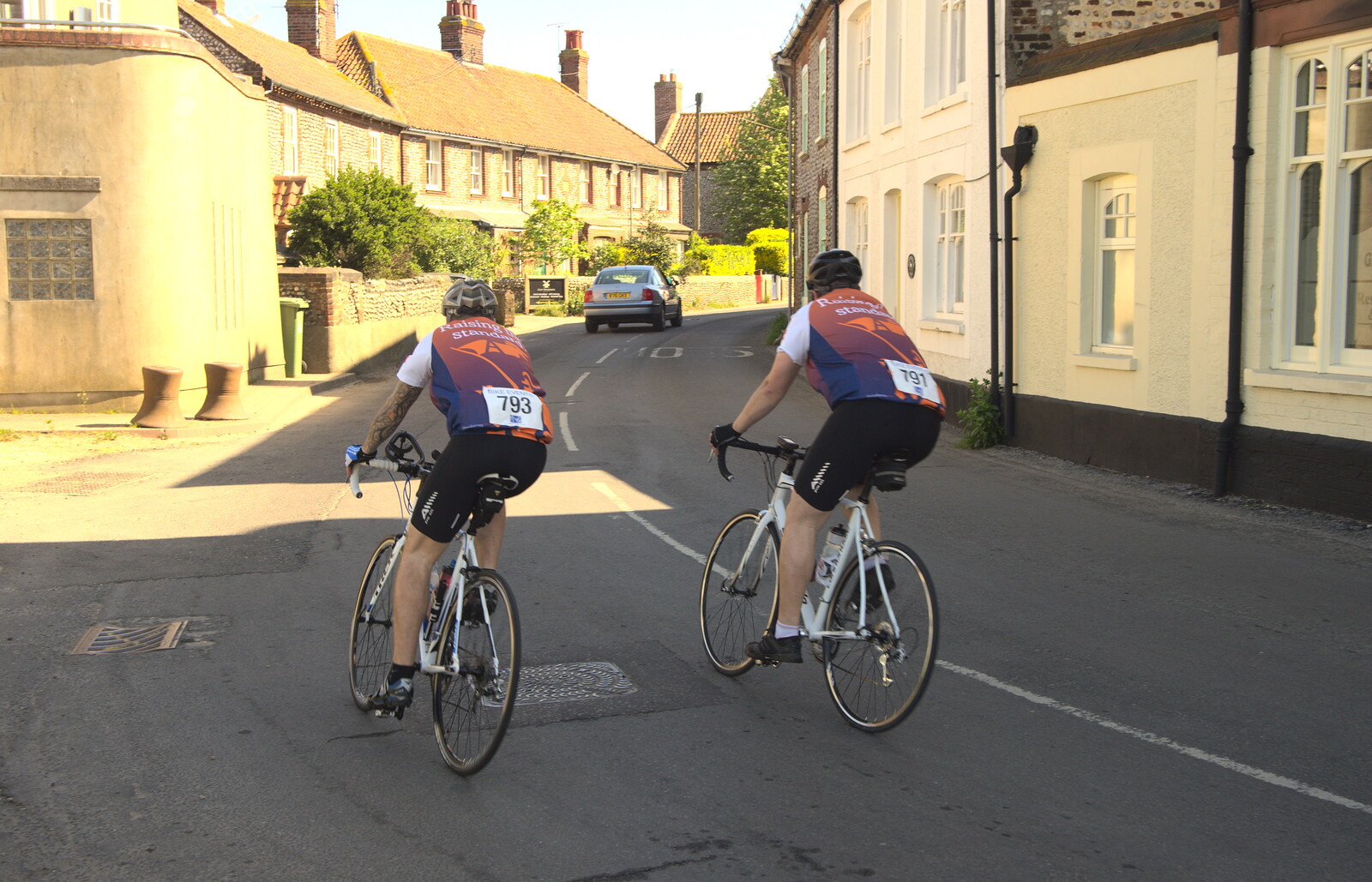 Another pair of cyclists heads through Cley from The BSCC at Needham, and a Birthday By The Sea, Cley, Norfolk - 26th May 2012