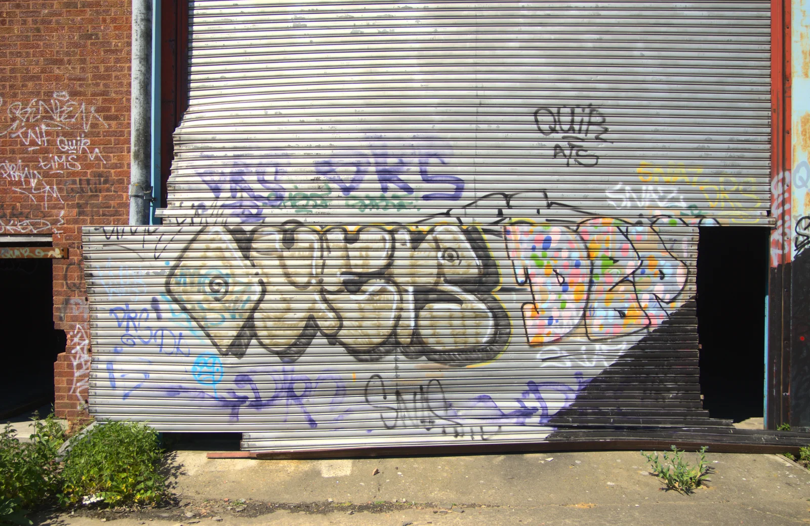 Graffiti on a wrecked roll-up door, from Rural Norfolk Dereliction and Graffiti, Ipswich Road, Norwich - 27th May 2012