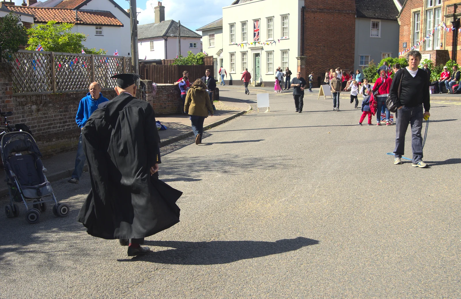 The headmaster wanders off up Church Street, from The Queen's Diamond Jubilee Weekend, Eye and Brome, Suffolk - 4th June 2012