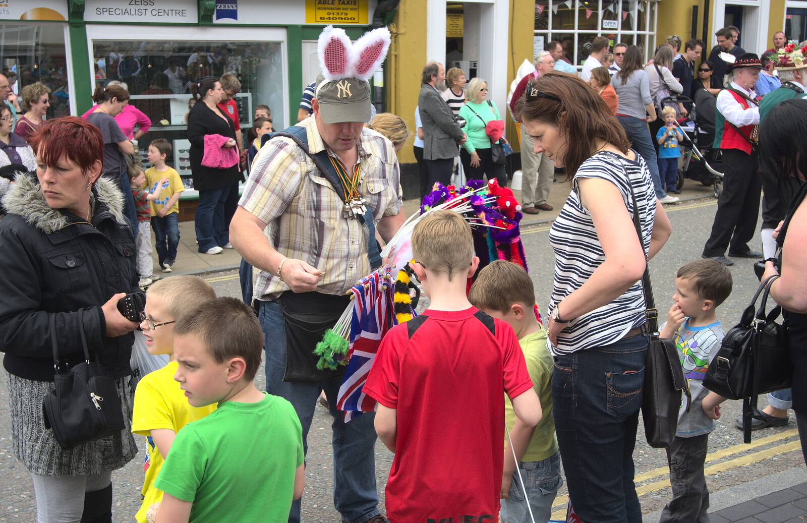 A dude with rabbit ears hands flags out from Morris Dancing and a Carnival Procession, Diss, Norfolk - 17th June 2012