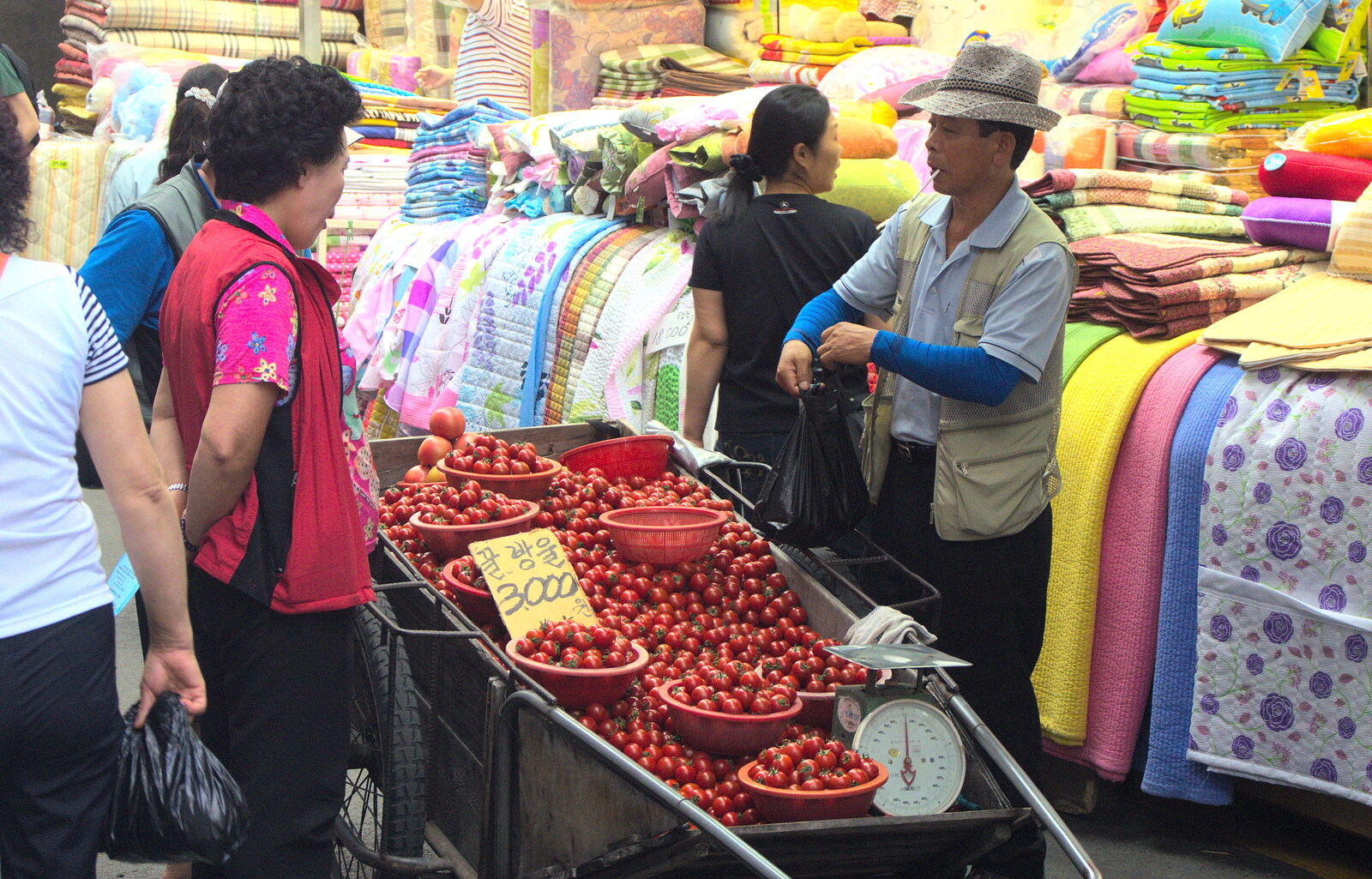 A tomato seller in action from Seomun Market, Daegu, South Korea - 1st July 2012