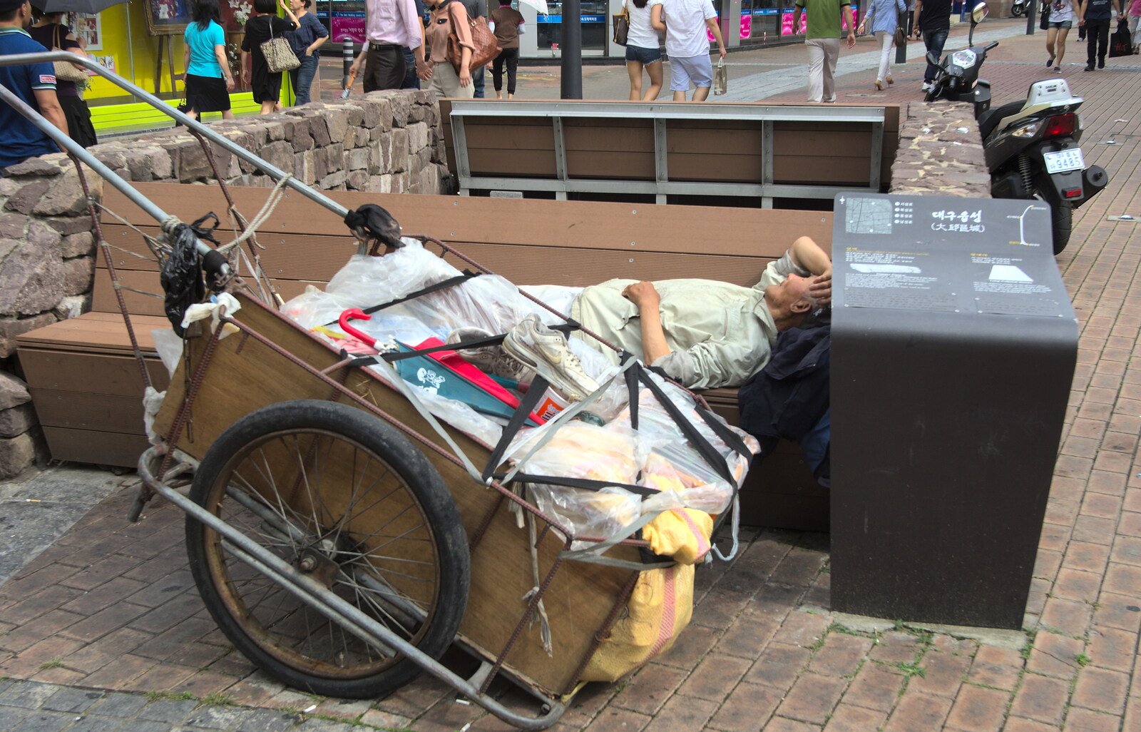 A sleeping homeless dude with his world in a cart from Seomun Market, Daegu, South Korea - 1st July 2012