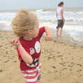 Fred lobs rocks in to the waves, Camping by the Seaside, Cliff House, Dunwich, Suffolk - 15th August 2012
