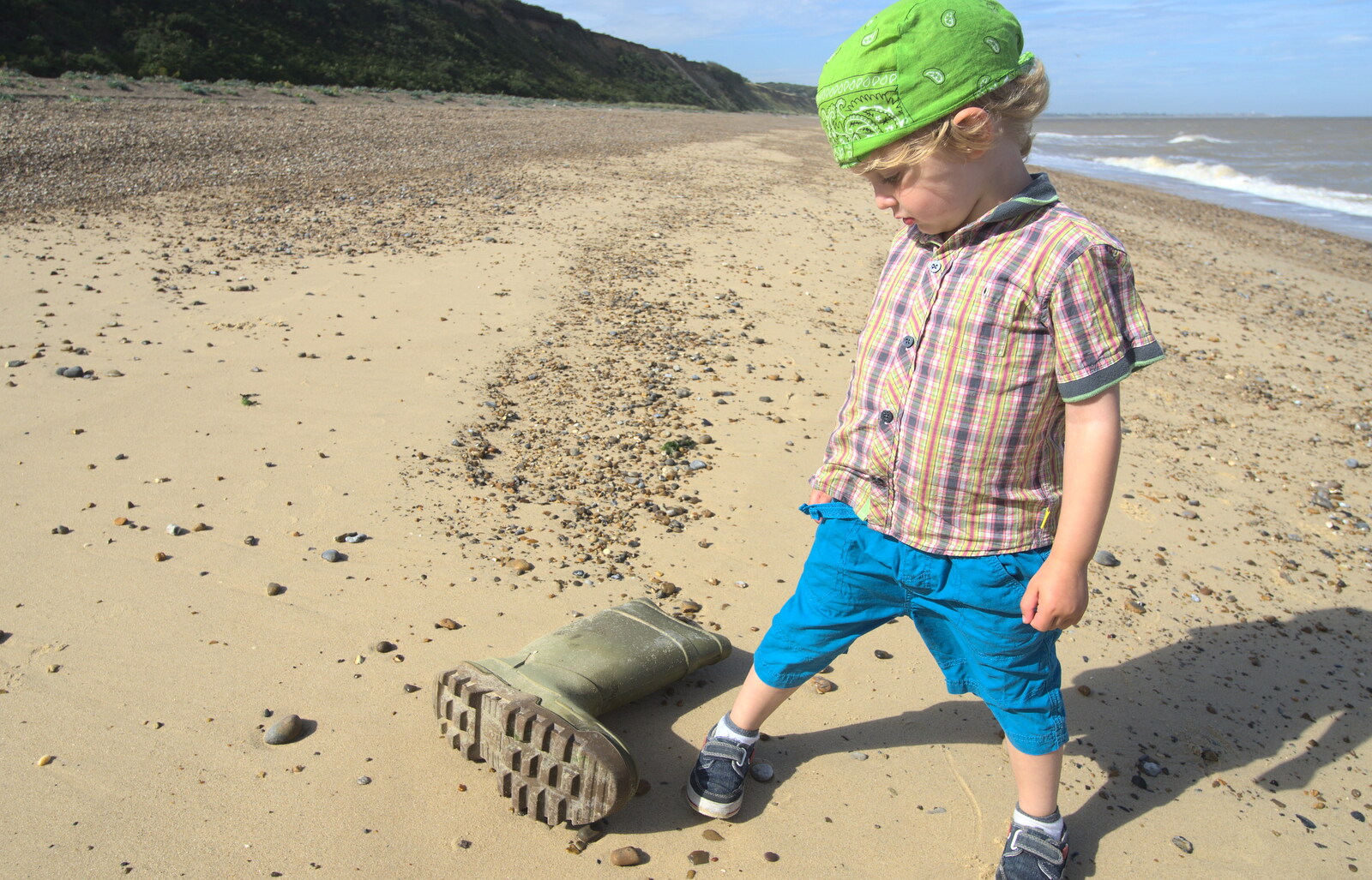 Fred discovers a huge welly boot on the beach from Camping by the Seaside, Cliff House, Dunwich, Suffolk - 15th August 2012