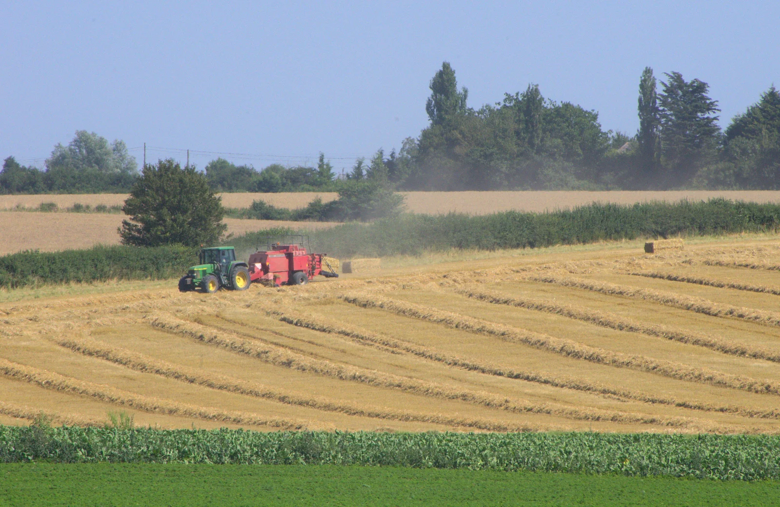 A baler works its way around a field, from "Grandma Julie's" Barbeque Thrash, Bressingham, Norfolk - 19th August 2012