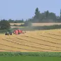 A baler works its way around a field, "Grandma Julie's" Barbeque Thrash, Bressingham, Norfolk - 19th August 2012