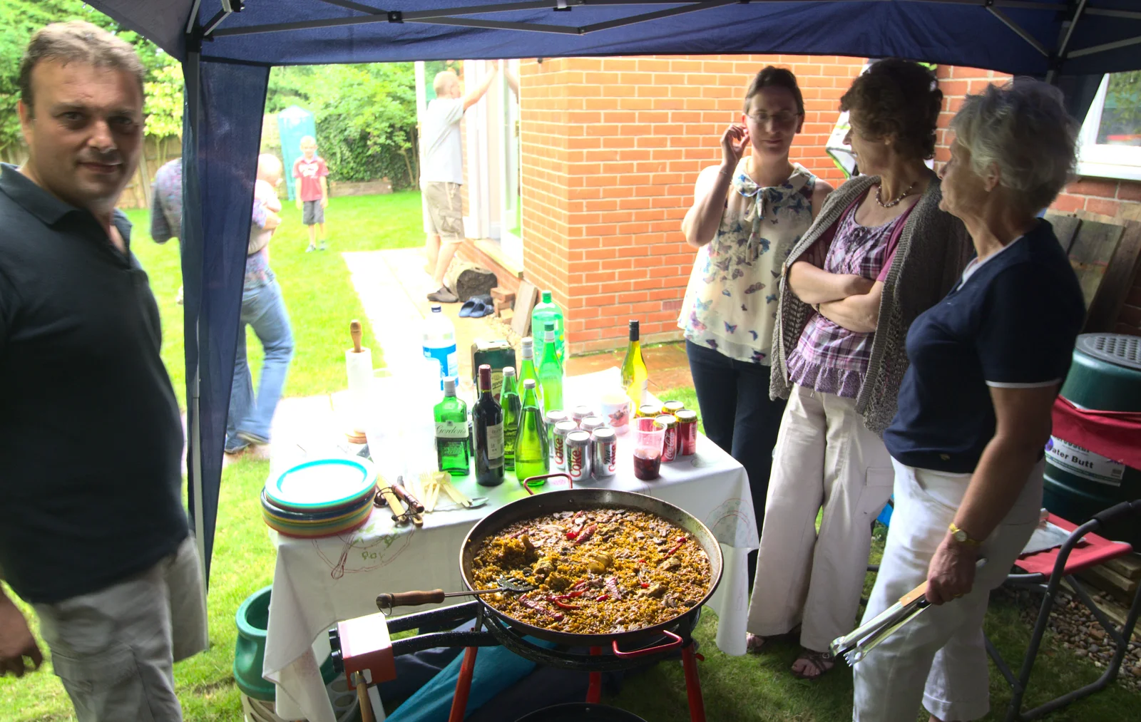 Suey looks over across the paellera, from Bill and Carmen's Paella Barbeque, and a Trip to the City, Yaxley and Norwich - 25th August 2012