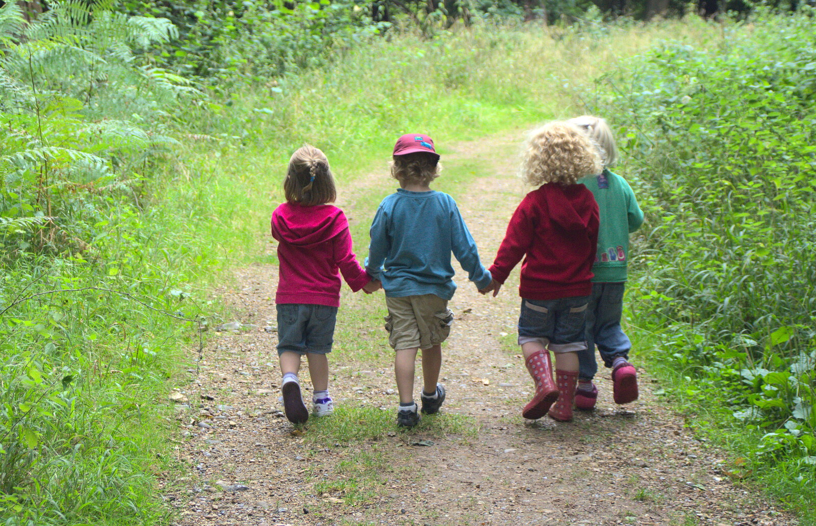 Sophie, Fred, Rosie and Grace walk hand-in-hand from Camping at Dower House, West Harling, Norfolk - 1st September 2012