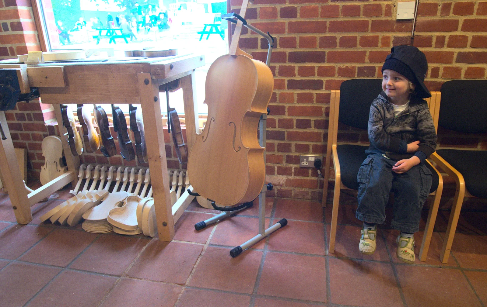 Fred waits around next to an unfinished cello, from The Aldeburgh Food Festival, Aldeburgh, Suffolk - 30th September 2012