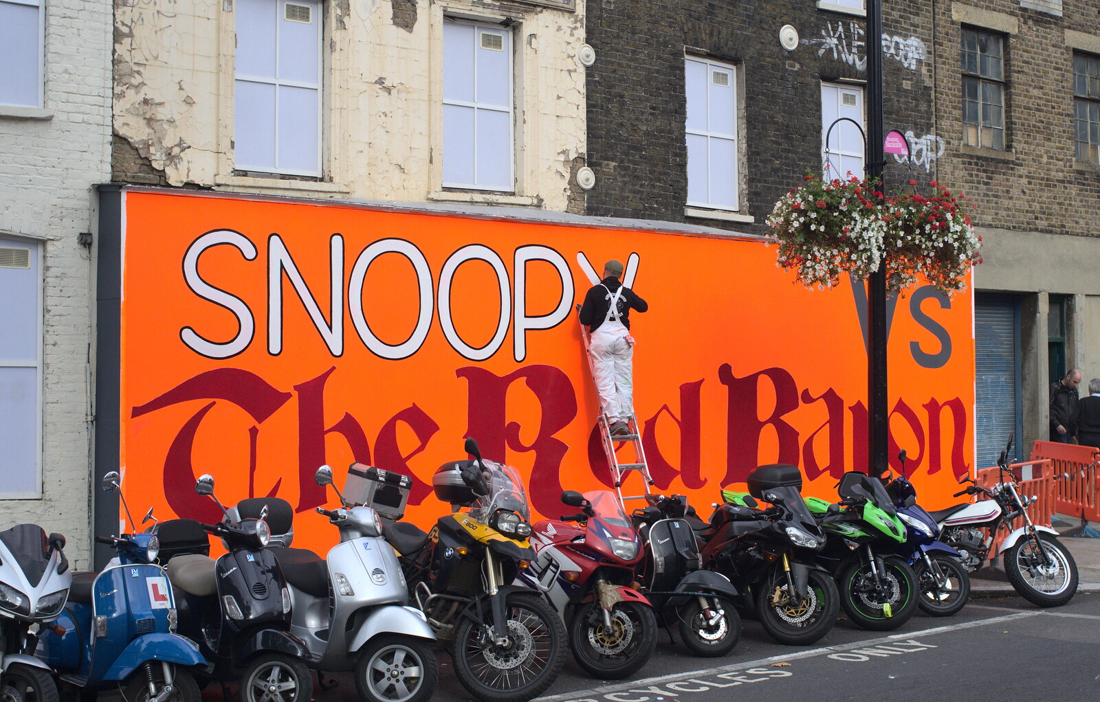 The signwriter paints an outline around 'Snoopy' from A TouchType Office Fire Drill, Southwark Bridge Road, London - 6th October 2012