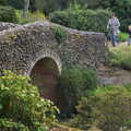 Isobel and Fred run over the flint bridge, Alan Bloom's Gardens, Bressingham, Norfolk - 6th October 2012
