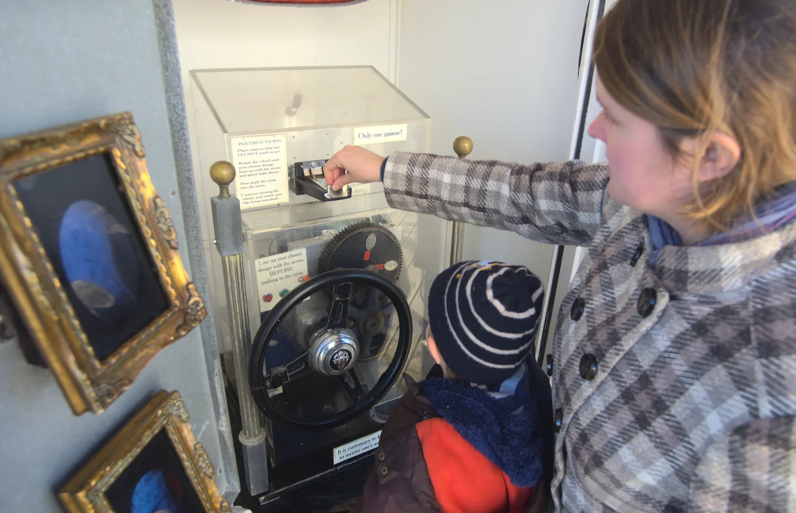 Isobel sticks some money in, from A Busy Day, Southwold and Thornham, Suffolk - 11th November 2012