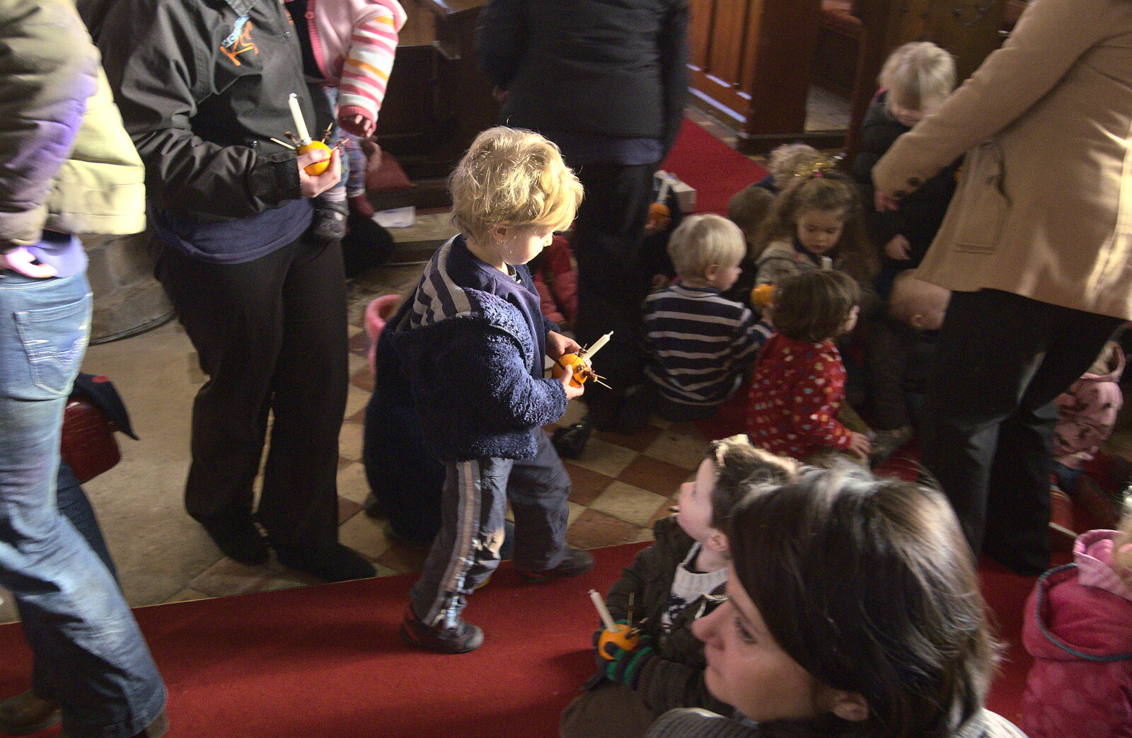 Fred runs off with a Christingle orange thingy from Fred's Nursery Nativity, Palgrave, Suffolk - 13th December 2012