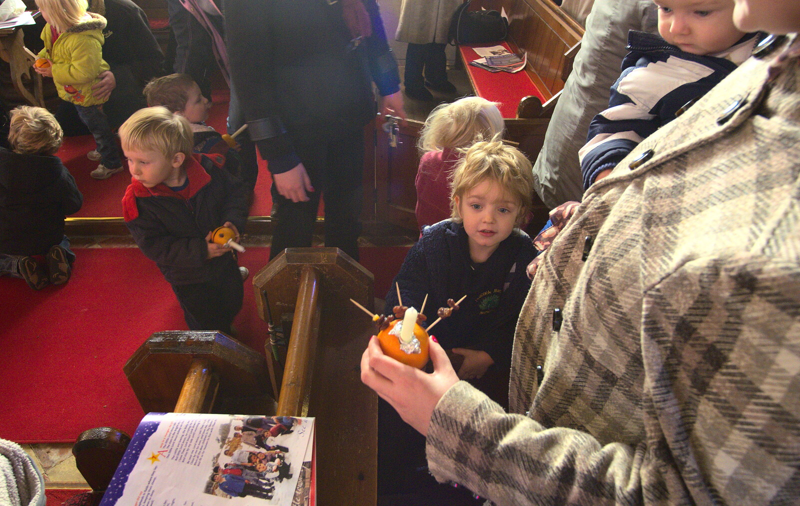 Isobel inspects the orange curiosity from Fred's Nursery Nativity, Palgrave, Suffolk - 13th December 2012