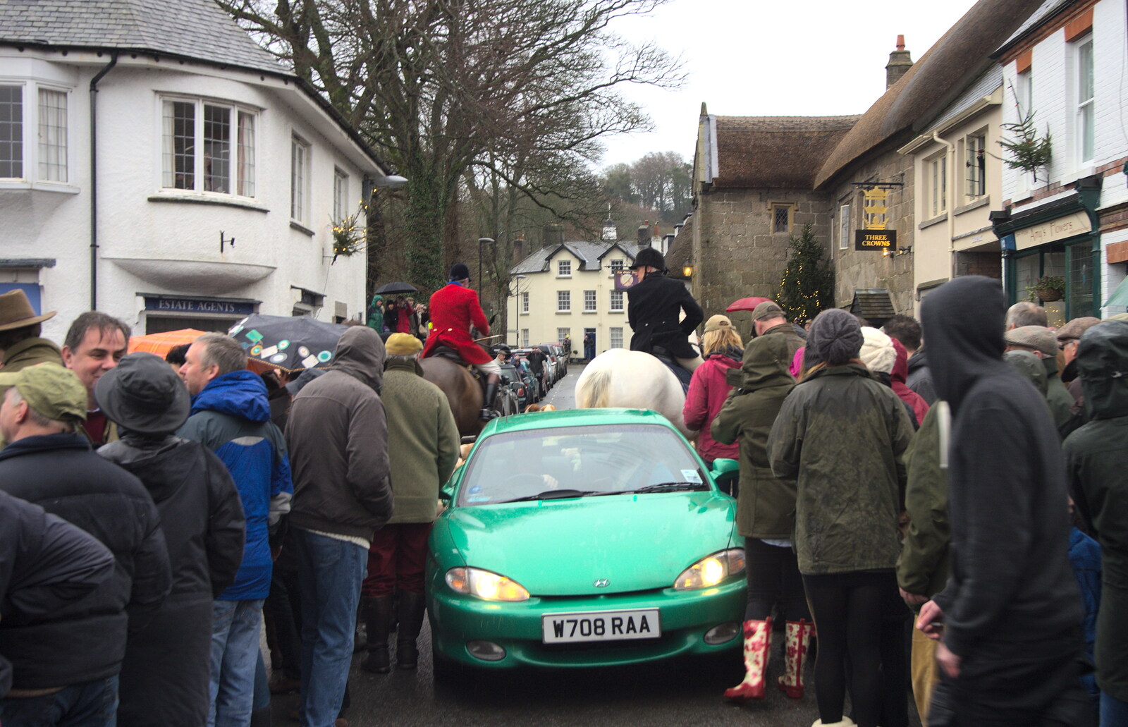 A car squeezes through the crowd on Mill Street from The Boxing Day Hunt, Chagford, Devon - 26th December 2012