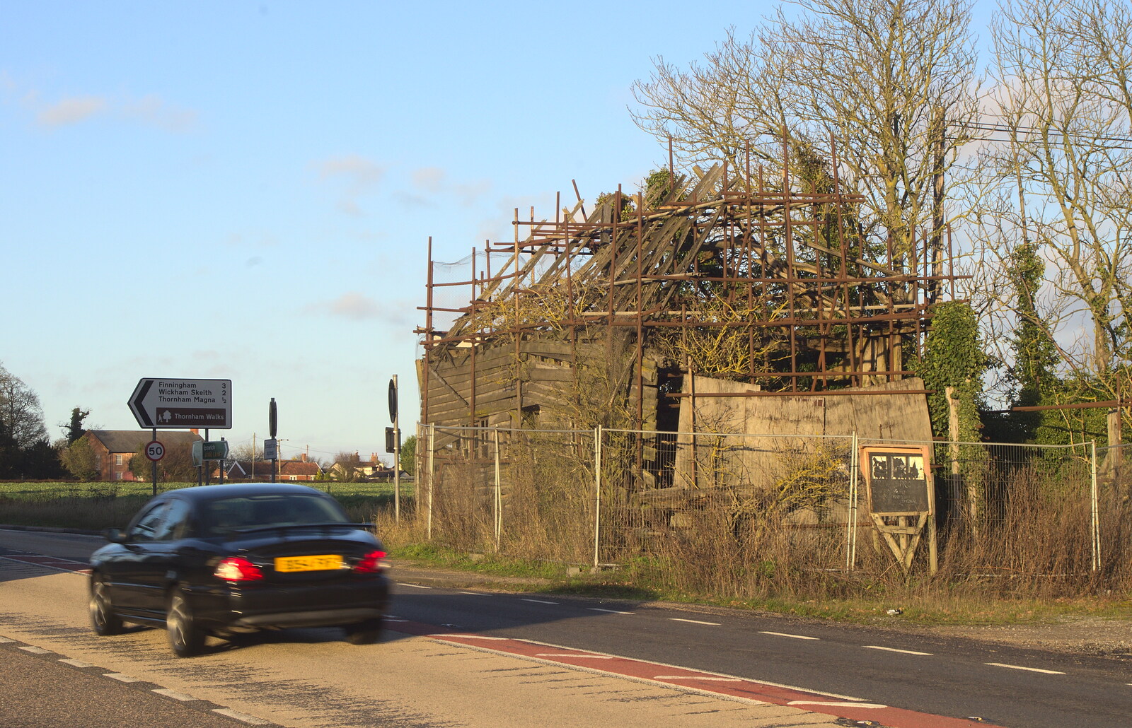 A car drives past the wrecked building from New Year's Day and Lunch at the White Horse, Ipswich, Finningham and Brome - 1st January 2013