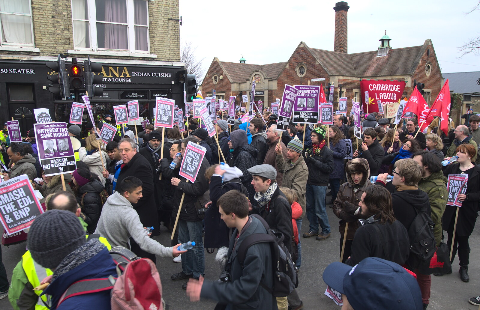 Massed placards, as water is handed out from An Anti-Fascist March, Mill Road, Cambridge - 23rd February 2013