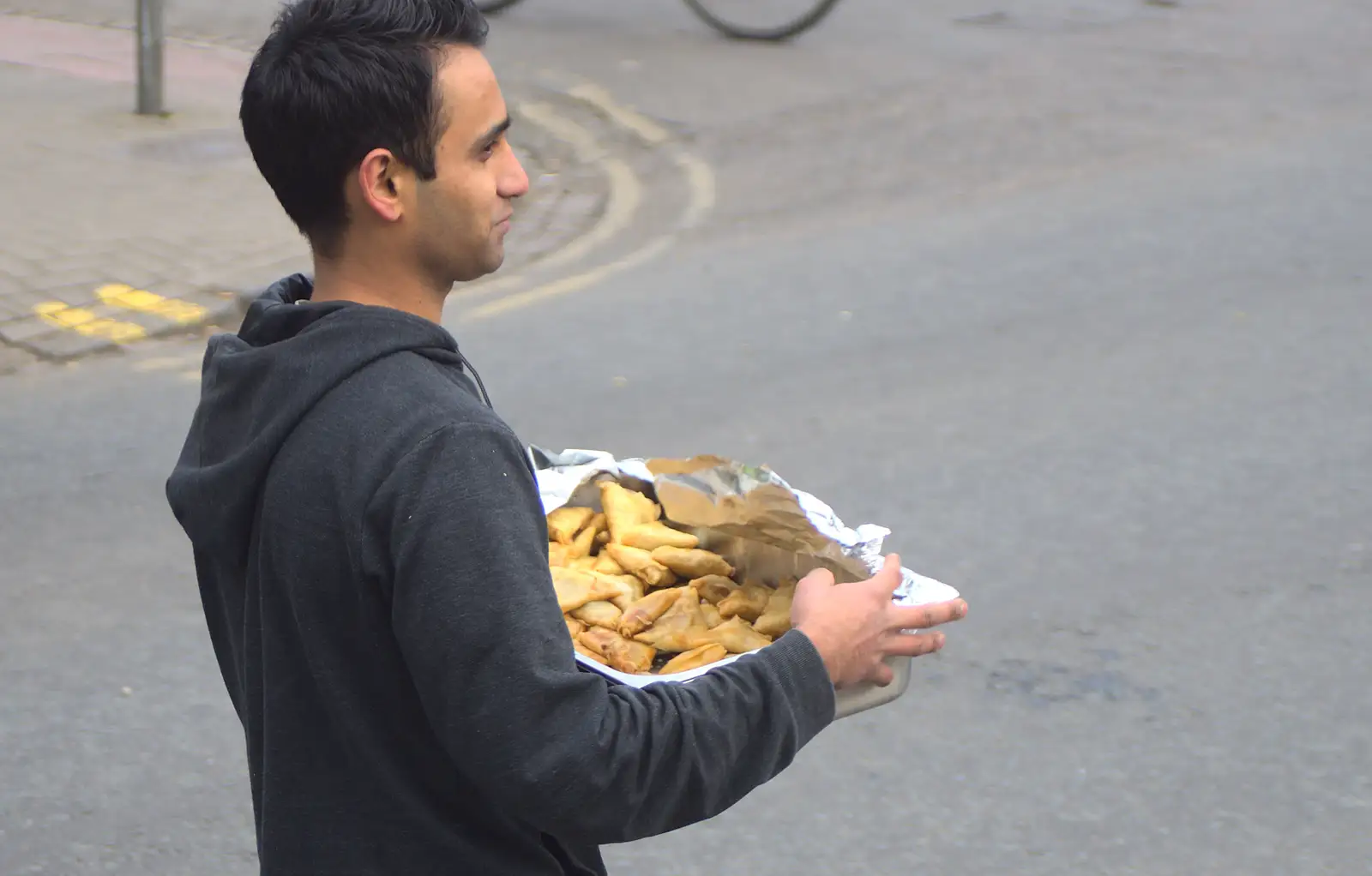 A dude passes samosas around, from An Anti-Fascist March, Mill Road, Cambridge - 23rd February 2013