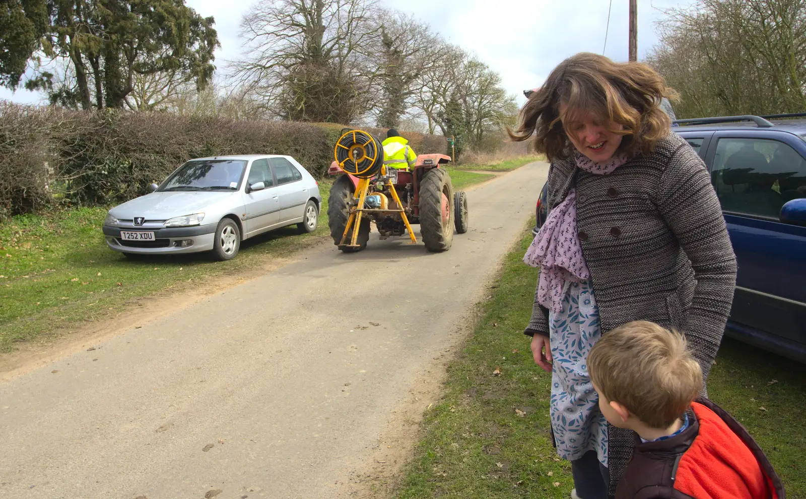 A tractor trundles down the road, from An Easter Visit from Da Gorls, Brome, Suffolk - 2nd April 2013