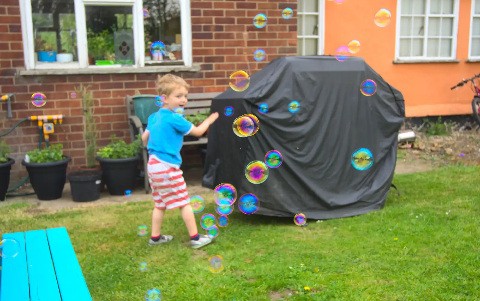 Fred runs away as bubbles chase him around, from Rosie and Henry's Birthday Party, Mellis, Suffolk - 5th May 2013