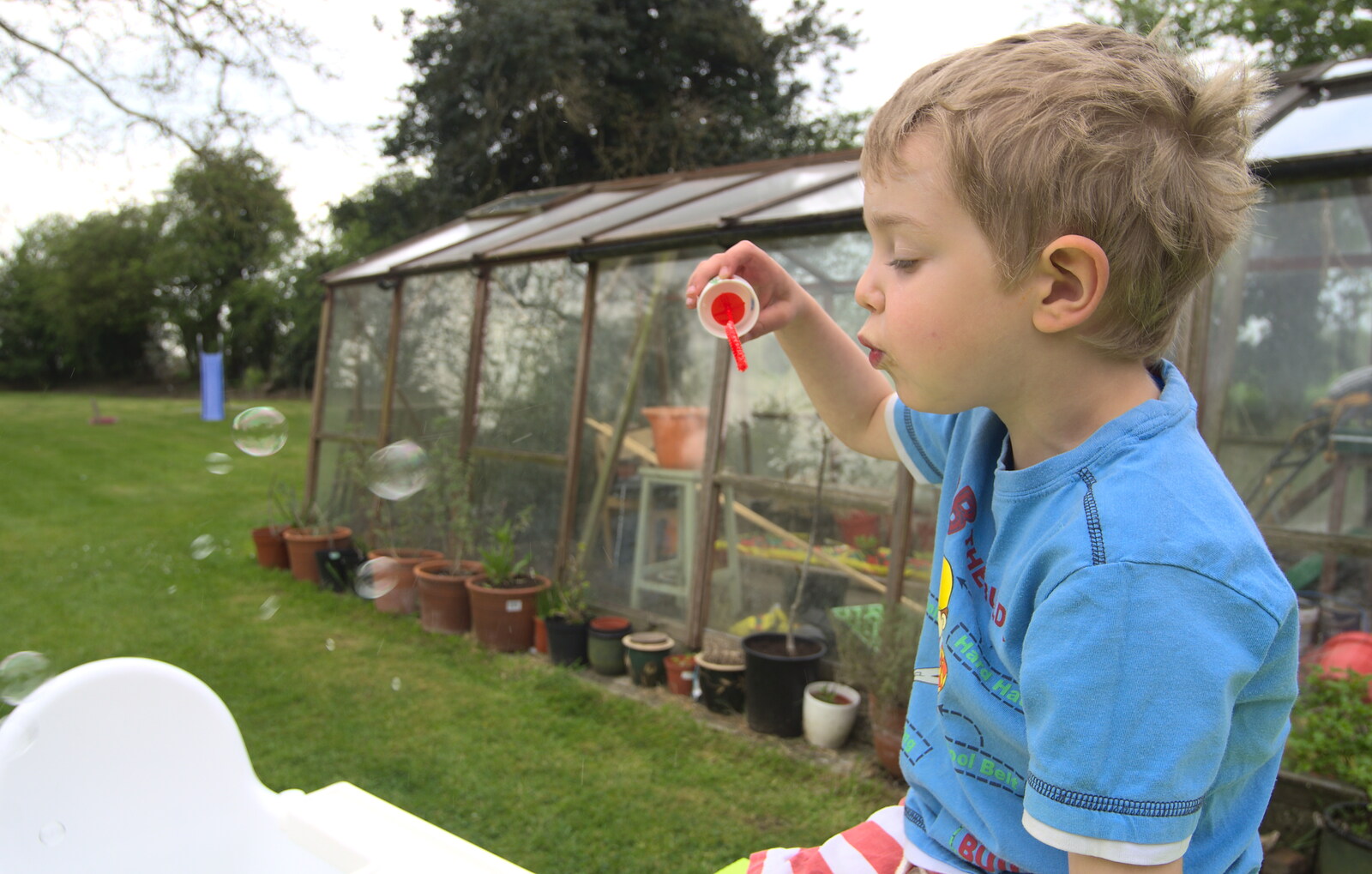 Fred blows bubbles near the greenhouse from Bank Holiday Flowers, Brome, Suffolk - 6th May 2013