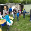 Carrie hands a bag of cans over, Demolishing The 1st Eye Scout Hut, Wellington Road, Eye, Suffolk - 11th May 2013