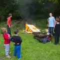 The door is hurled on the bonfire, Demolishing The 1st Eye Scout Hut, Wellington Road, Eye, Suffolk - 11th May 2013