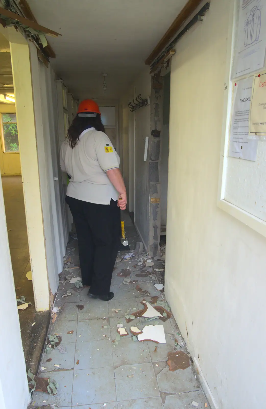 Carrie surveys the destruction, from Demolishing The 1st Eye Scout Hut, Wellington Road, Eye, Suffolk - 11th May 2013