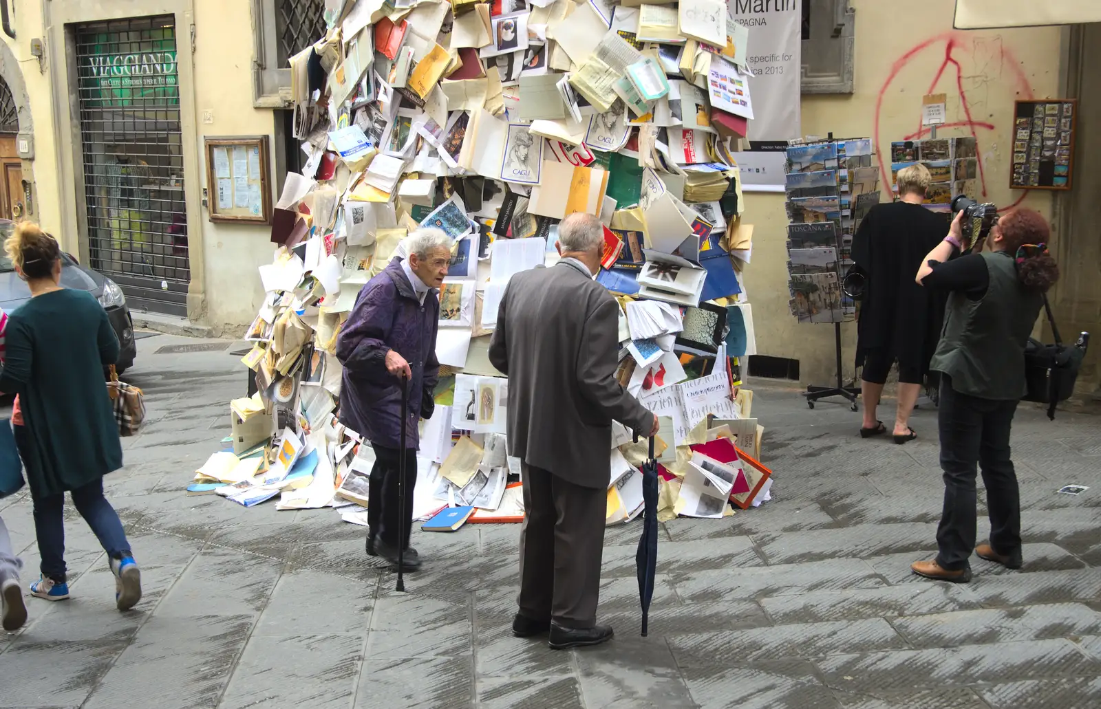 Passers-by inspect the pile of books, from Marconi, Arezzo and the Sagra del Maccherone Festival, Battifolle, Tuscany - 9th June 2013