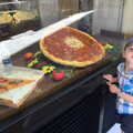 2013 Fred stands next to a giant pizza