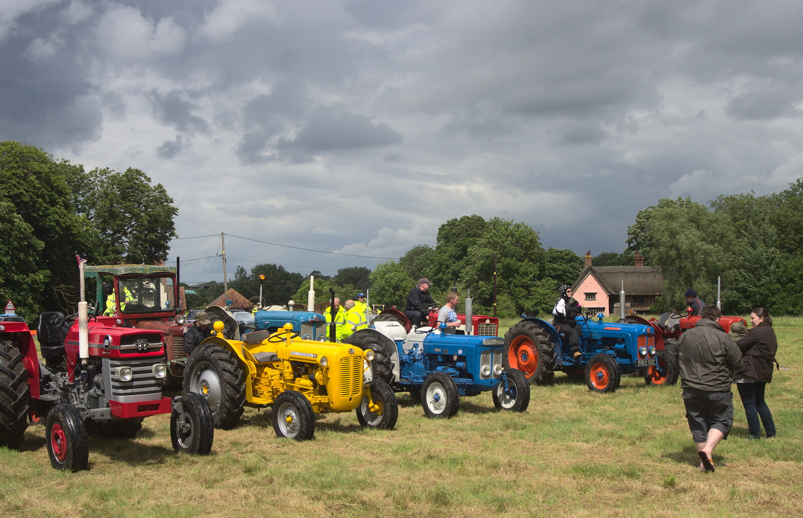 Multi-coloured tractors on the green from Thrandeston Pig Roast and Tractors, Thrandeston Little Green, Suffolk - 23rd June 2013