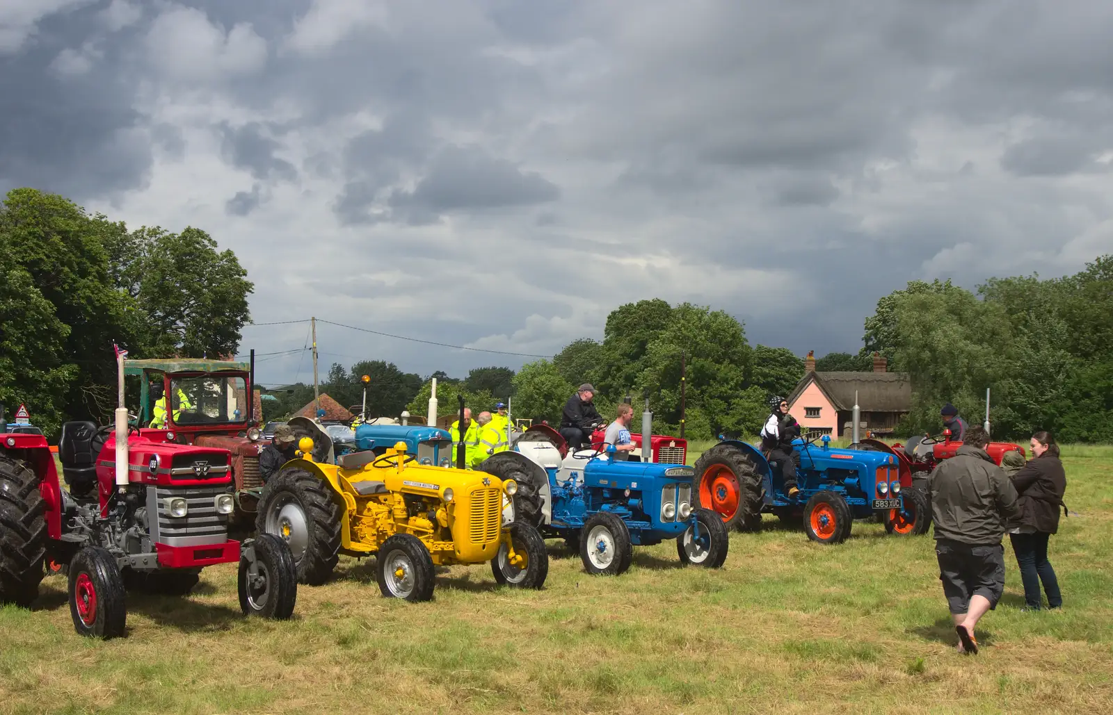 Multi-coloured tractors on the green, from Thrandeston Pig Roast and Tractors, Thrandeston Little Green, Suffolk - 23rd June 2013