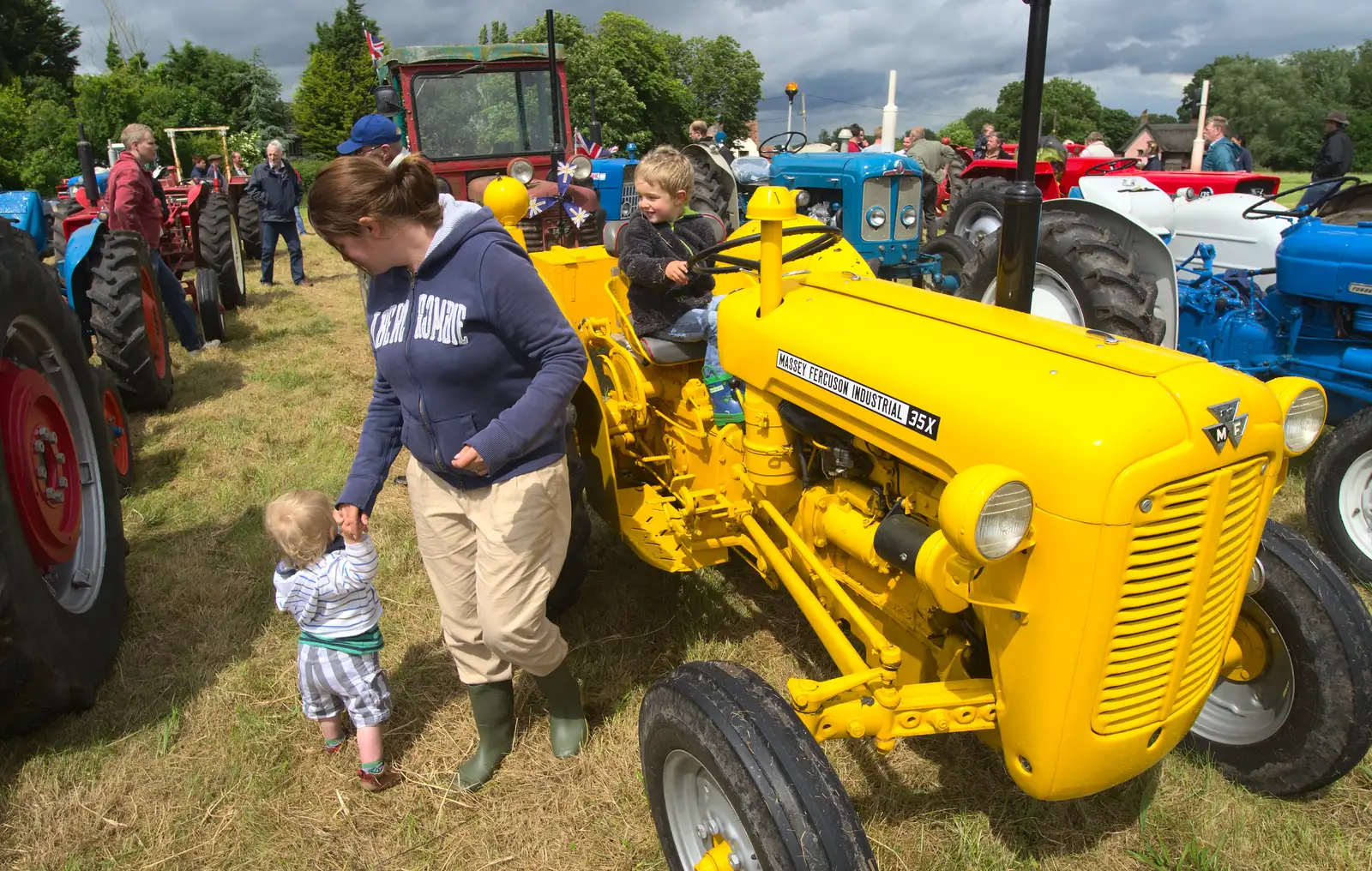 Fred has a go on the bright yellow tractor, from Thrandeston Pig Roast and Tractors, Thrandeston Little Green, Suffolk - 23rd June 2013