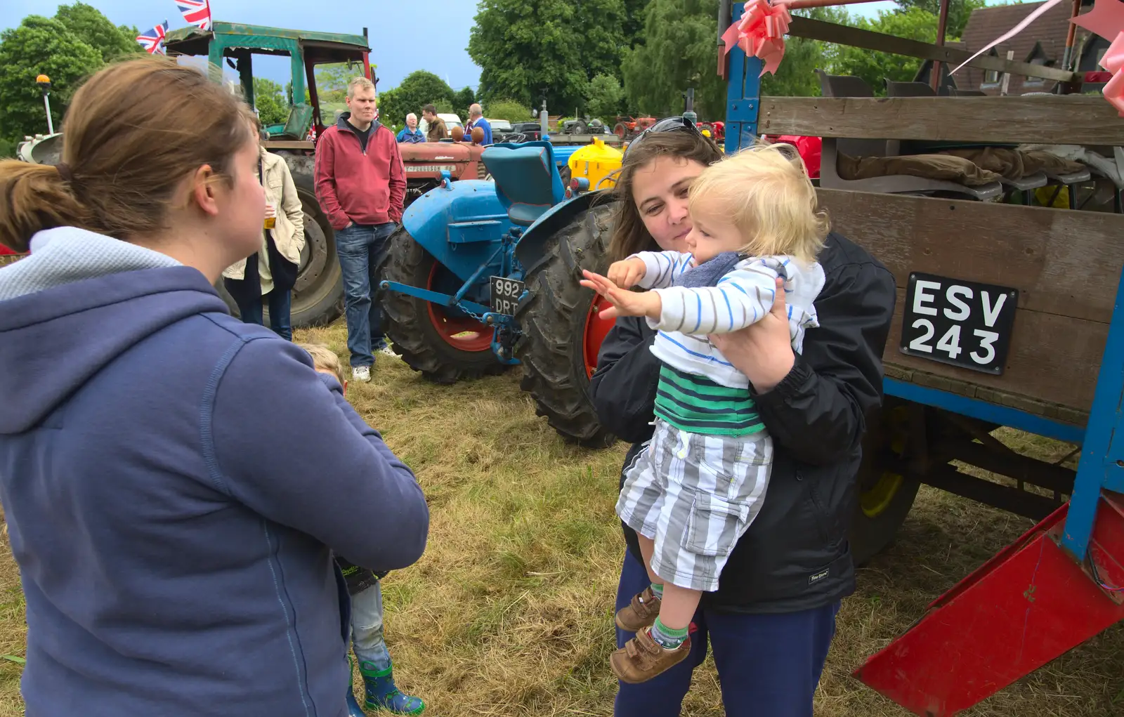 Claire scoops Harry up, from Thrandeston Pig Roast and Tractors, Thrandeston Little Green, Suffolk - 23rd June 2013