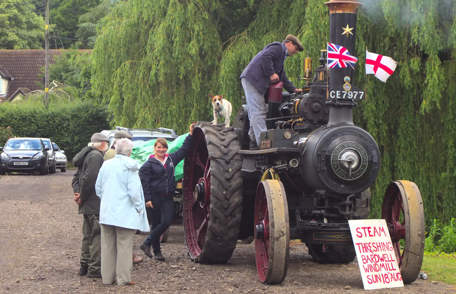 A small dog perches on the wheels of the engine, from Thrandeston Pig Roast and Tractors, Thrandeston Little Green, Suffolk - 23rd June 2013