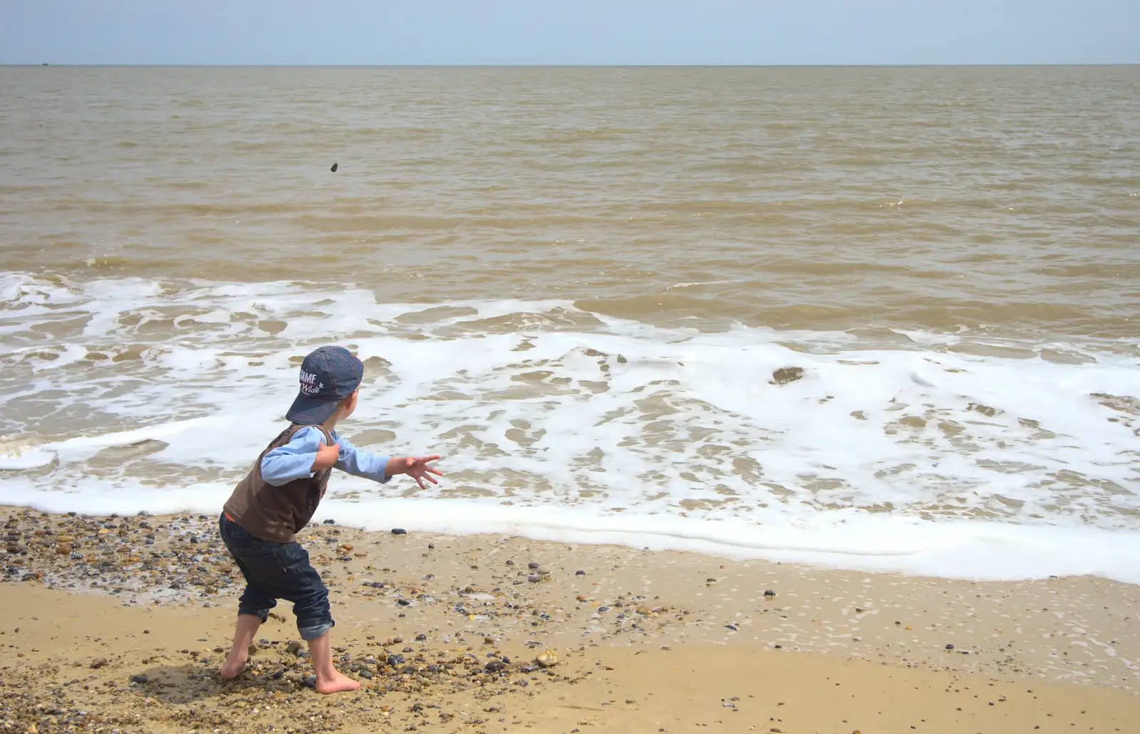 Fred lobs stones at the sea, from Petrol Station Destruction, and a Cliff House Camping Trip, Southwark and Dunwich, Suffolk - 30th June 2013