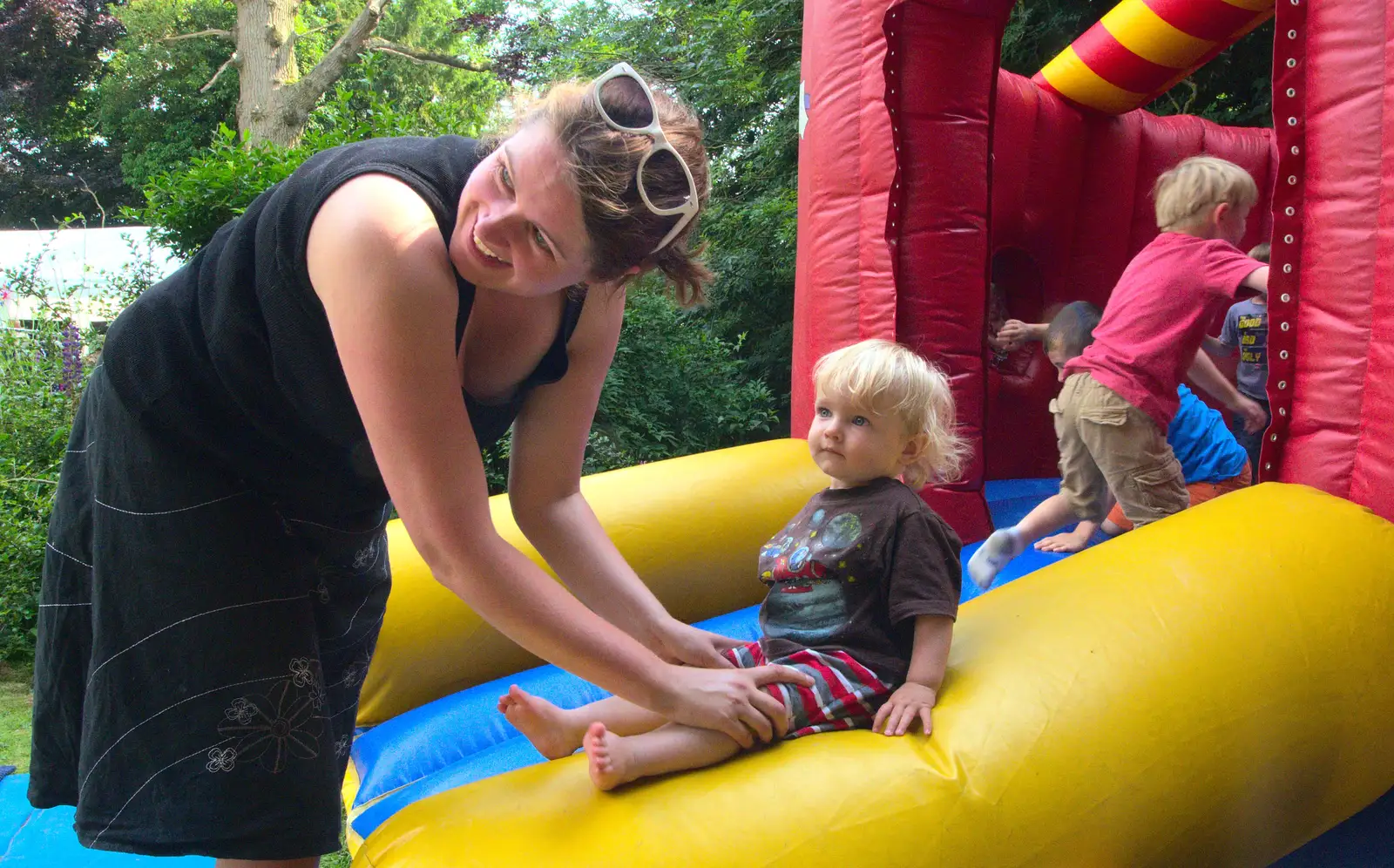 Isobel helps Harry off the bouncy castle, from Marconi's Demolition and Brome Village Fete, Chelmsford and Brome, Suffolk - 6th July 2013