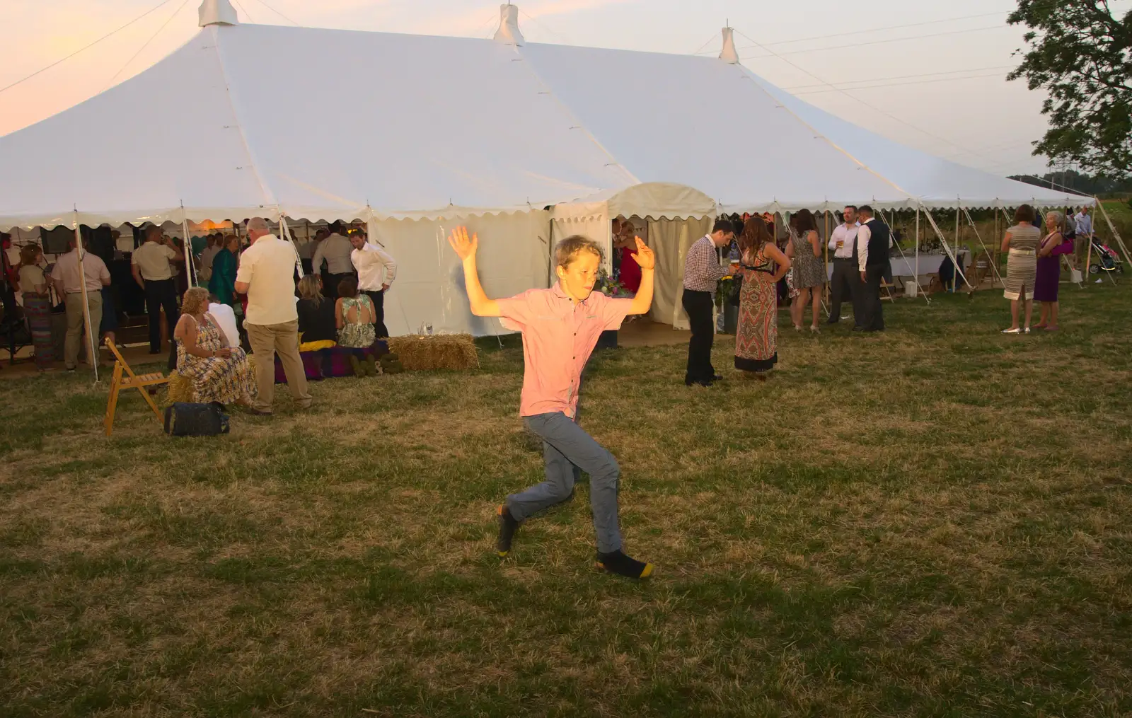 A small boy runs past and leaps in to the air, from The BBs Play Steph's Wedding, Burston, Norfolk - 13th July 2013