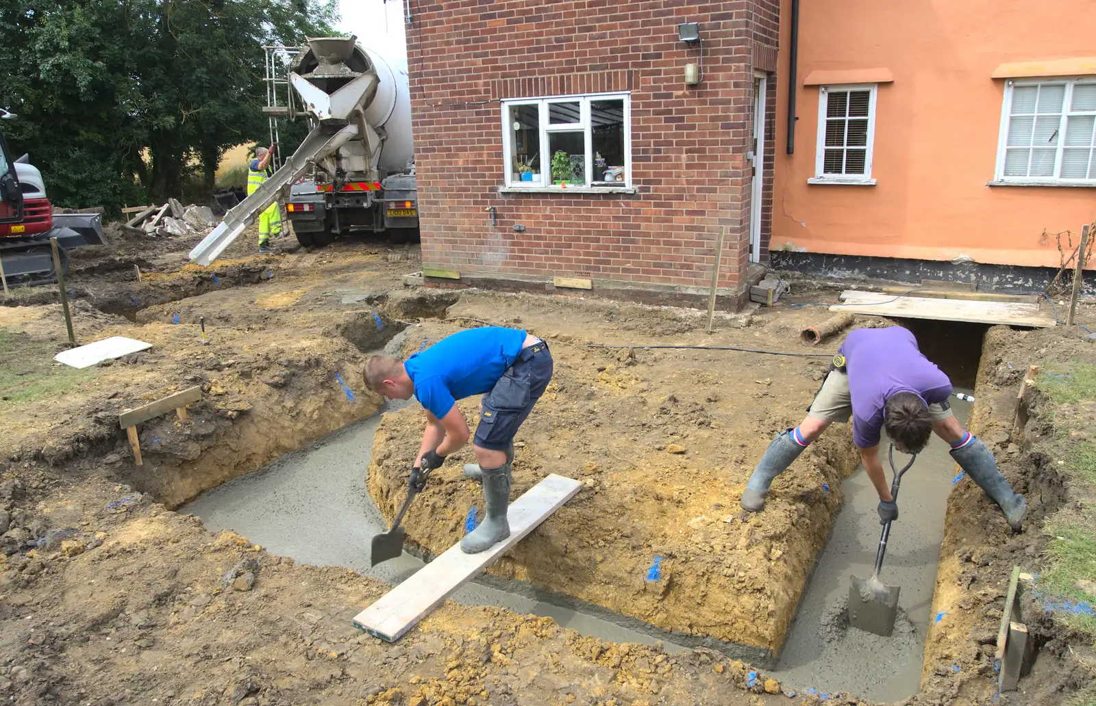 Lewis and Brian help the concrete on its way, from Grand Designs: Building Commences, Brome, Suffolk - 8th August 2013