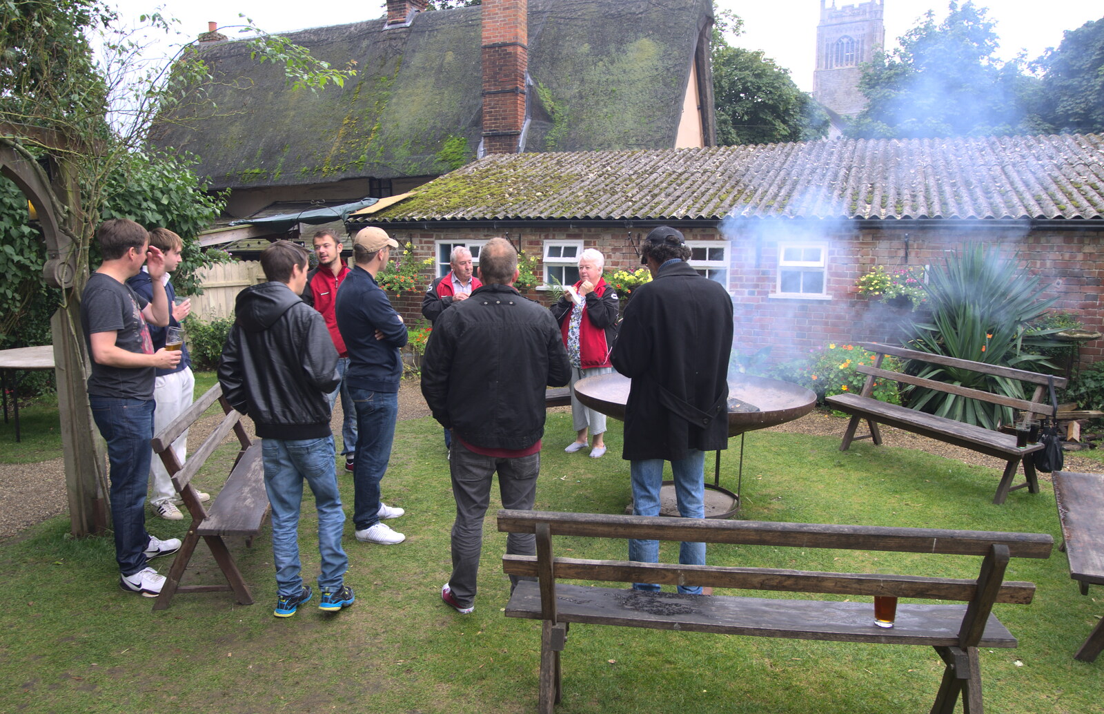 People crowd around the fire pit from The Low House Beer Festival, Laxfield, Suffolk - 15th September 2013