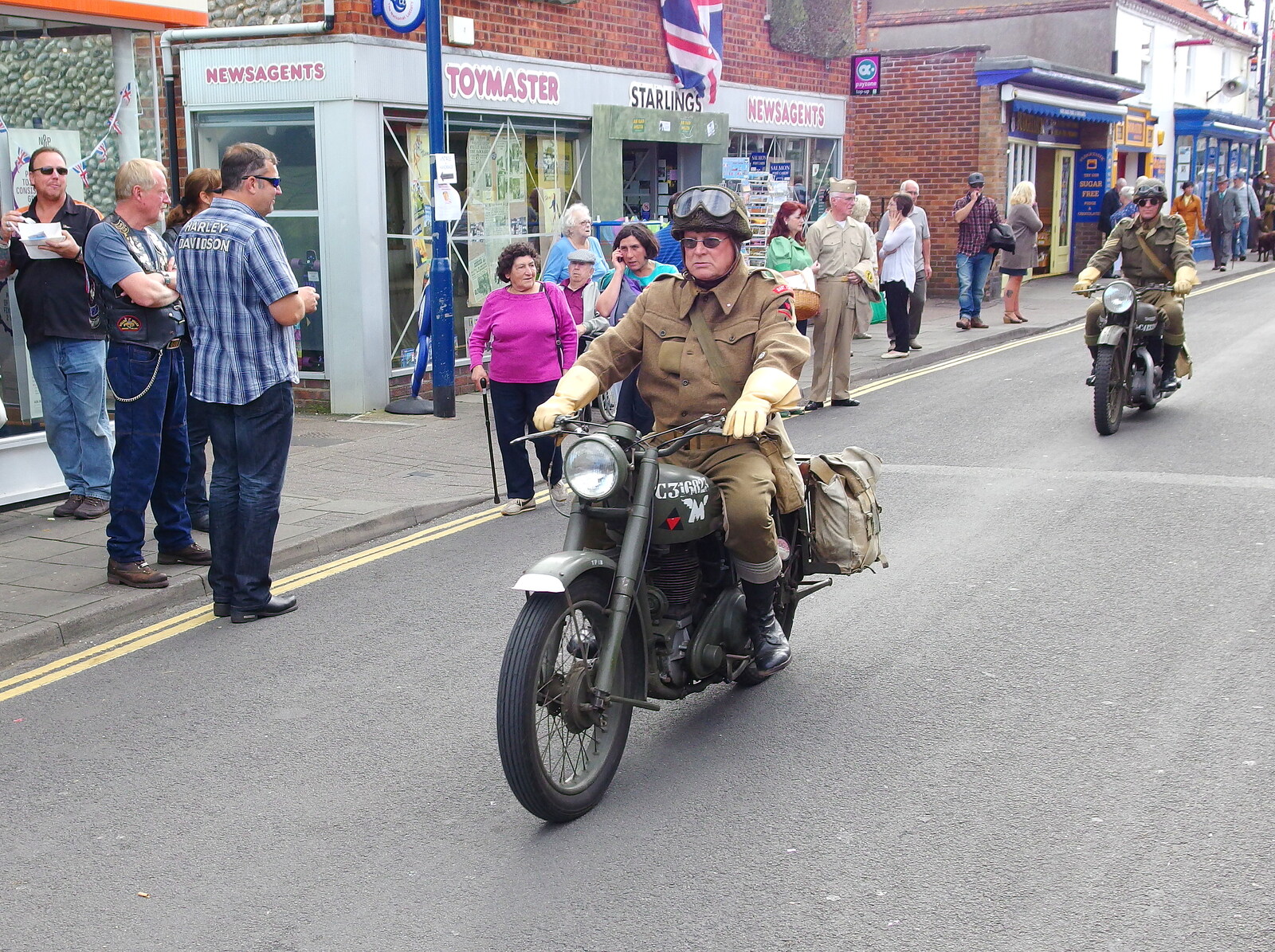 Wartime motorbikes cruise through town from Paul Bear's Adventures at a 1940s Steam Weekend, Holt, Norfolk - 22nd September 2013