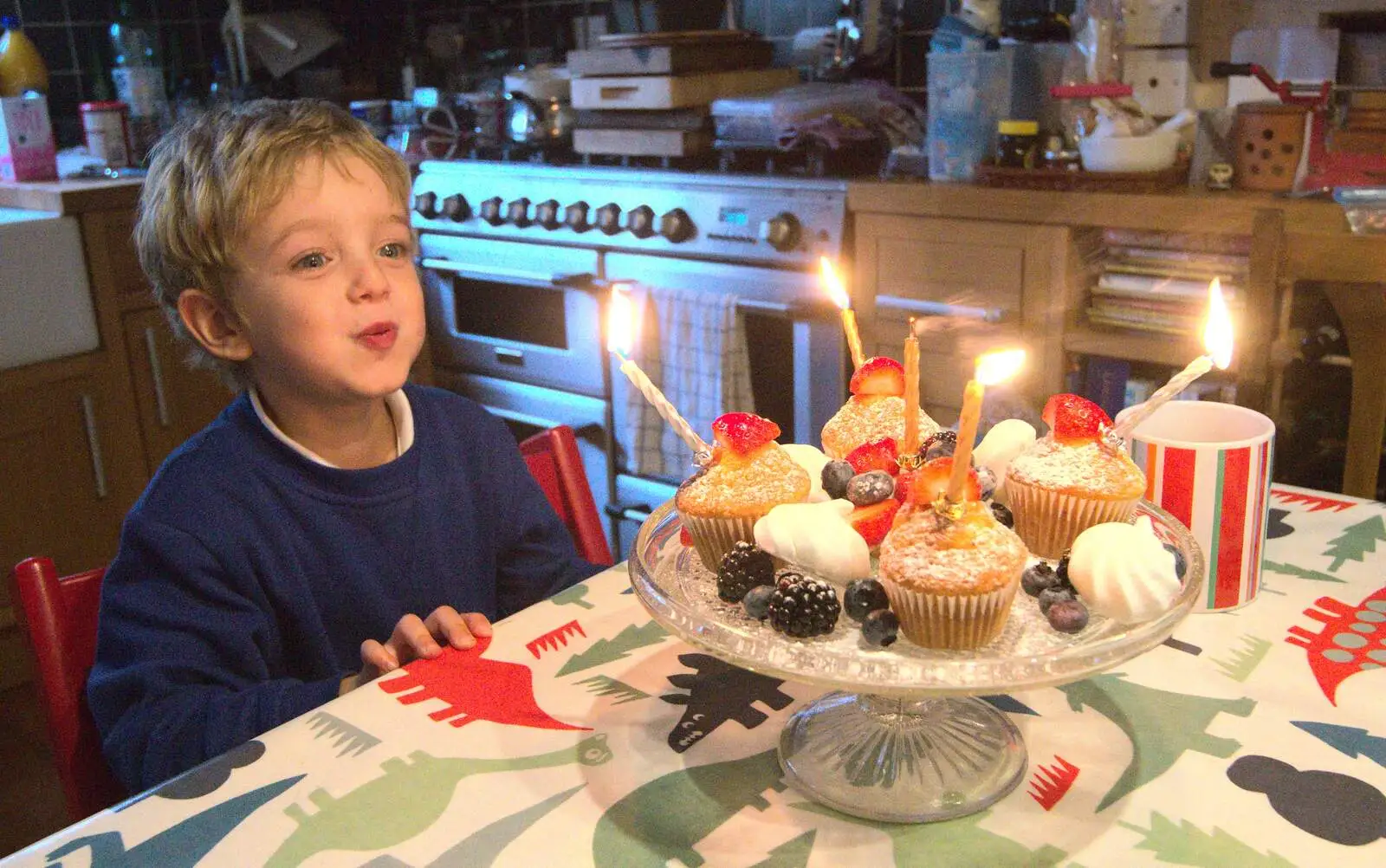 Fred blows out cupcake candles, from Fred's Fifth Birthday, The Village Hall, Brome, Suffolk - 28th September 2013